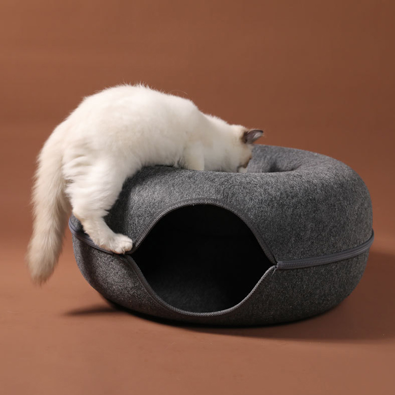 alt = "A white cat putting his head on the cat bed tunnel seat" 